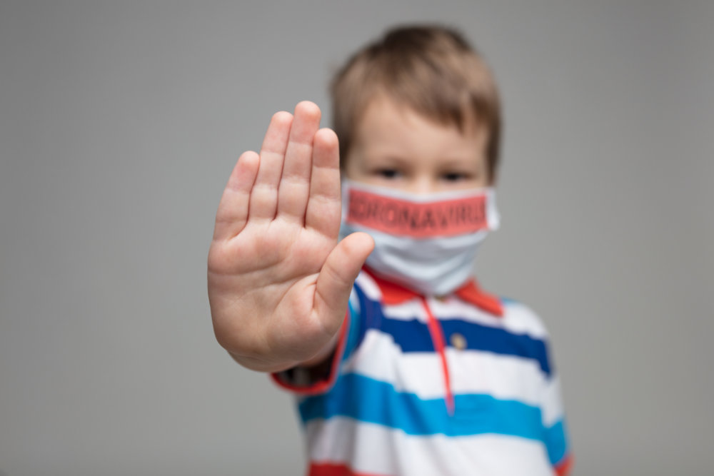 Young child wearing a respiratory mask as a prevention against the deadly Coronavirus Covid-19