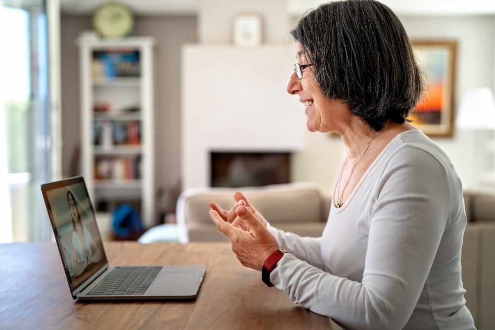 Adult woman having a video meeting with her solicitor online on a laptop.