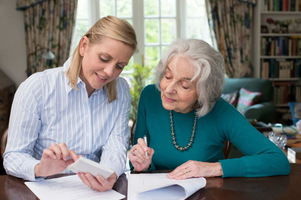woman helping senior with paperwork