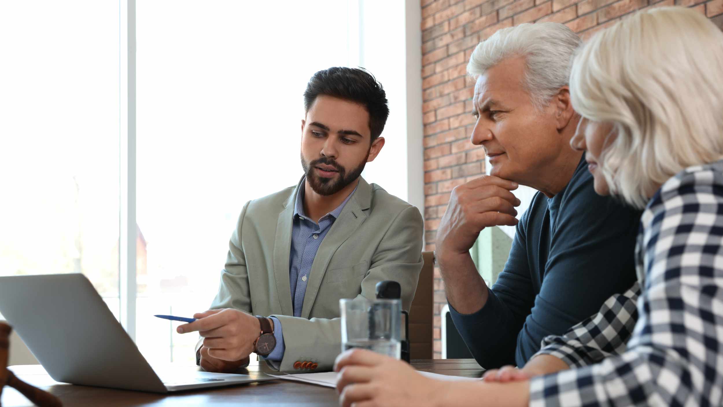 Male notary working with mature couple in office