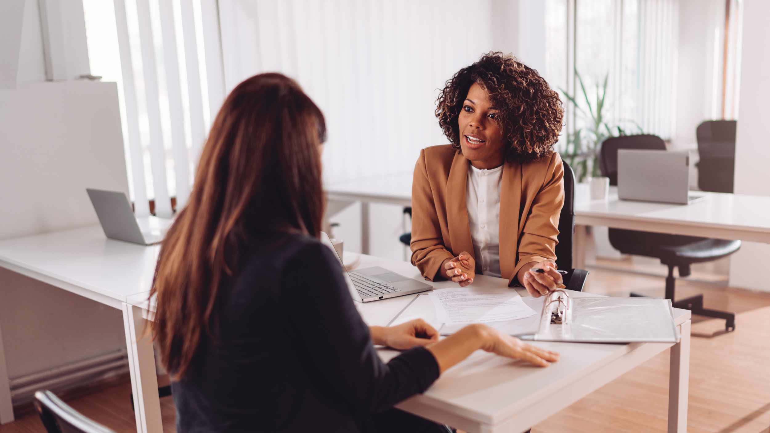 Financial consultant manager talking with a female client at the bank