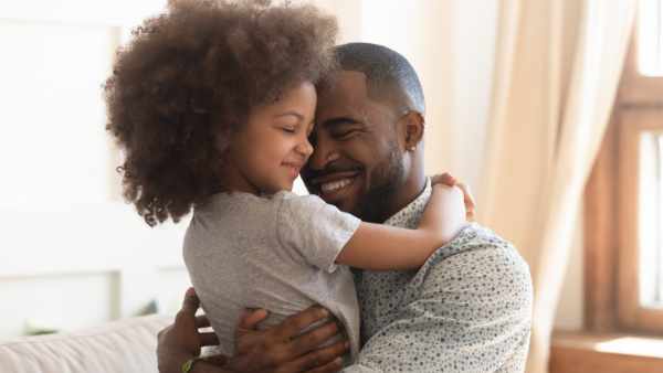 Sweet moments of fatherhood concept, happy african father hold embrace cute little child daughter, smiling black family mixed race daddy and small kid hugging cuddling enjoying time together at home