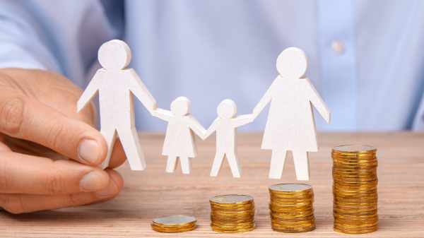 Budget of the family. Coins pile and the symbol of the family