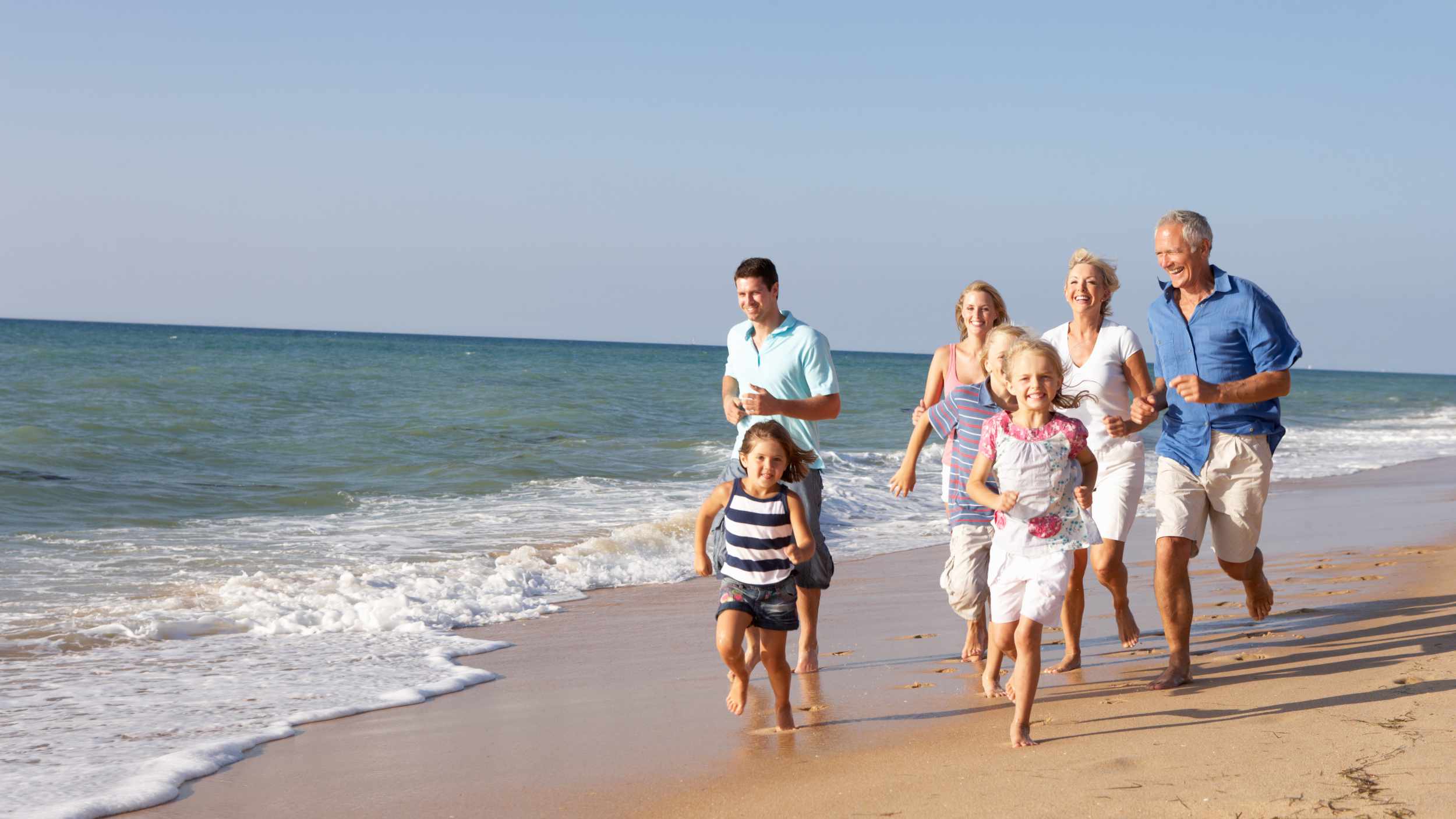 Portrait Of Three Generation Family On Beach Holiday