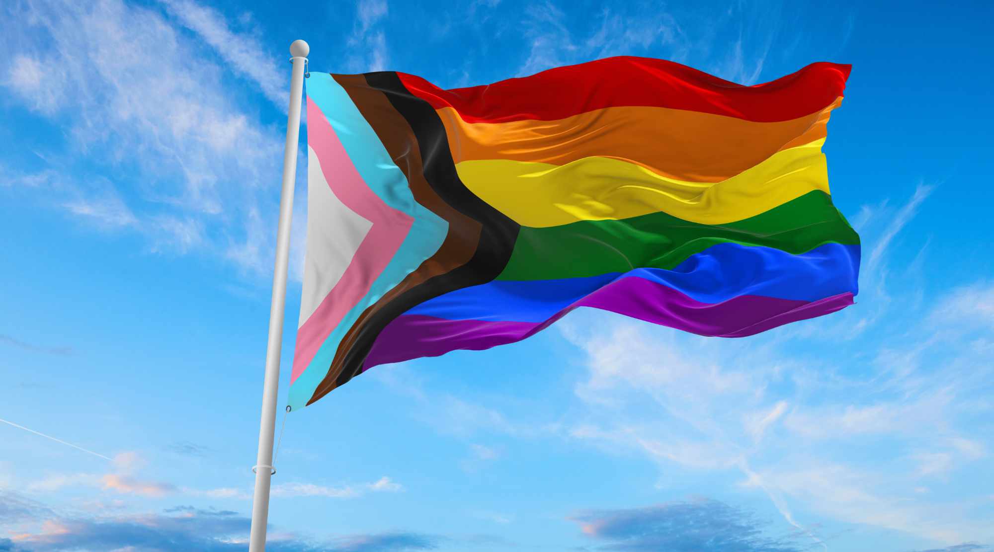 Progress LGBTQ rainbow flag waving in the wind at cloudy sky. Freedom and love concept. Pride month. activism, community and freedom Concept. Copy space. 3d illustration.
