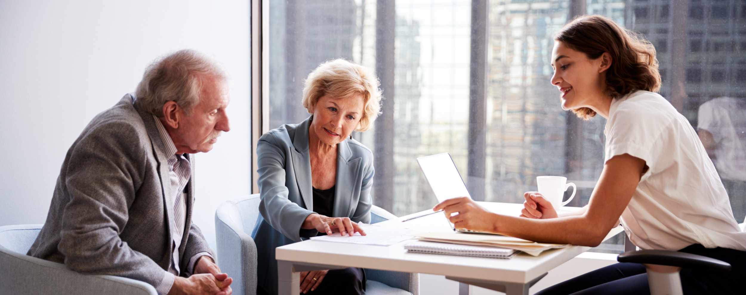 Senior Couple Meeting With Female Financial Advisor In Office